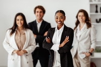Preview: Diversity and business team portrait. Business people posing in office interior and smiling at