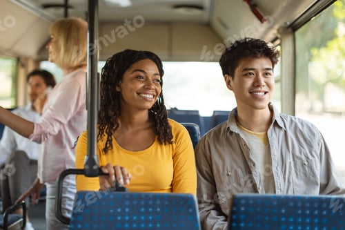 Preview: Cheerful asian guy and black lady taking bus together