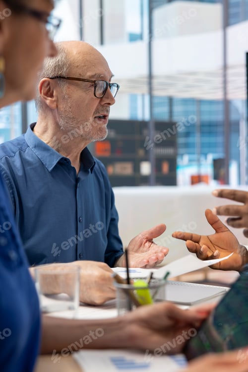 Preview: Mature couple meeting with financial expert to develop detailed retirement plan