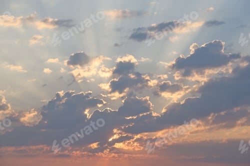 Preview: Beautiful sunrise with warm orange sunlight and beams through blue sky