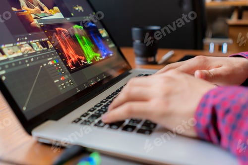 Preview: male producer edit video on his laptop in studio b