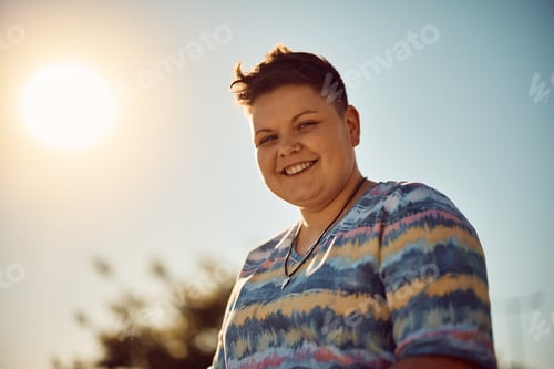 Preview: Portrait of happy homosexual woman against the sky looking at camera.
