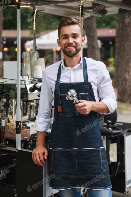 Preview: Handsome barista man during work in his street coffee shop