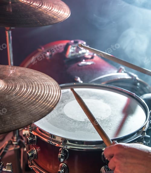 Preview: man plays the drum, flash of light, a beautiful light in the background with copy space