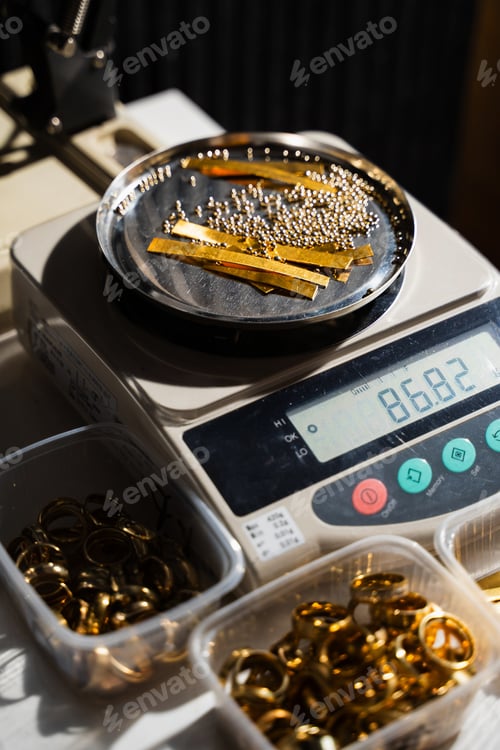 Preview: Jeweler precise weighing of gold pieces beads and scrap.