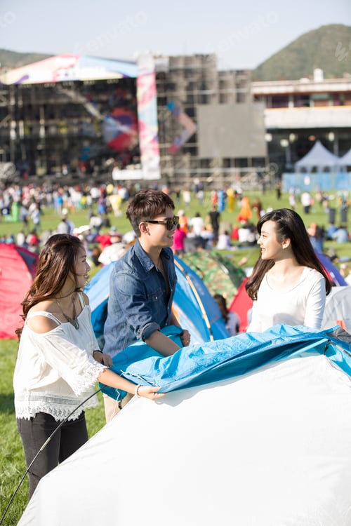 Preview: Friends setting up a tent on the grass