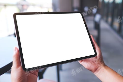 Preview: Mockup image of a woman holding digital tablet with blank white desktop screen in cafe