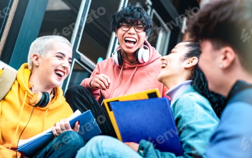 Preview: Multiracial students having fun together sitting outside school