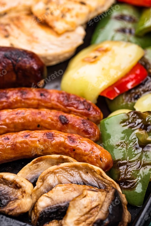 Preview: Grilled sausages, meat, and vegetables.