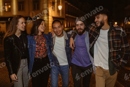 Preview: Group of friends laughing and having fun on a night out in town