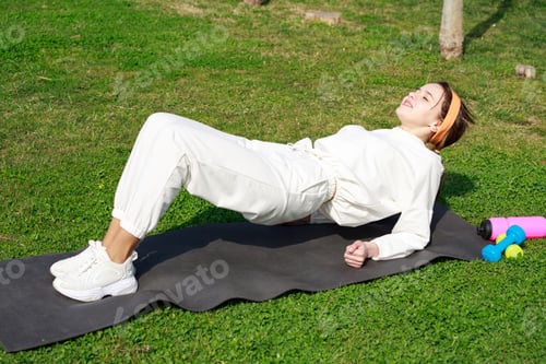 Preview: Young girl laying on the yoga mat and doing exercises