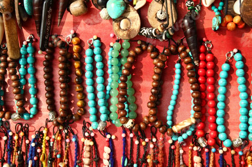 Preview: A lot of colorful bracelets and beads on a street market.