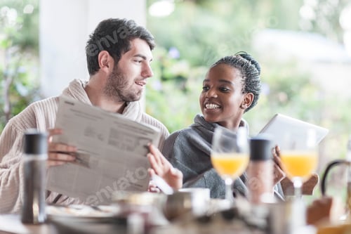 Preview: Young couple having breakfast on the terrace