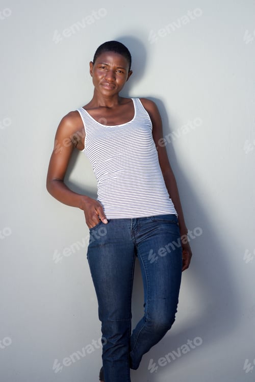 Preview: beautiful trendy black woman posing against wall