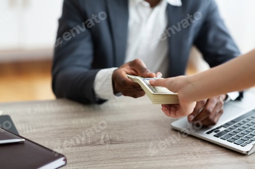 Preview: Unrecognizable black businessman accepting bribe from client, sealing the deal