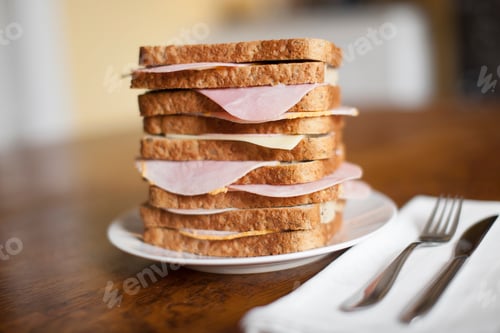 Preview: Stack of ham sandwiches on plate