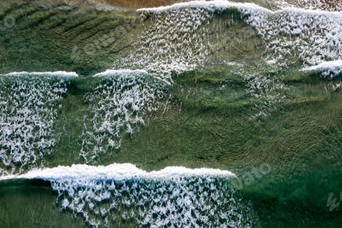 Preview: Beach, beautiful waves, blue water at sunrise. Top view from drone.