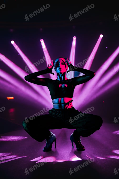Preview: Vertical shot of an attractive woman posing on a club stage with neon lights in the background
