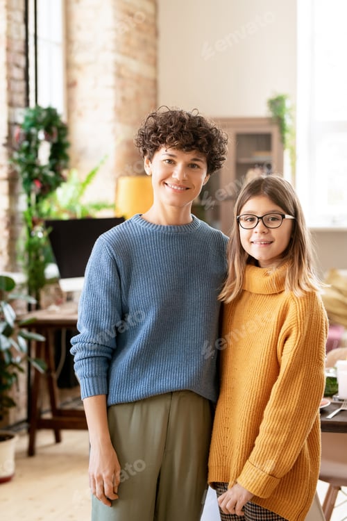 Preview: Young cheerful mother in casualwear embracing her cute teenage daughter