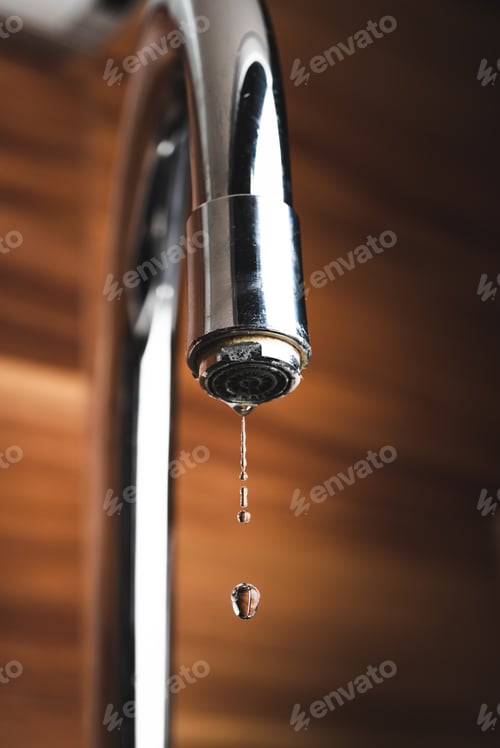 Preview: Metal tap and water drop close up. Lime stone in water