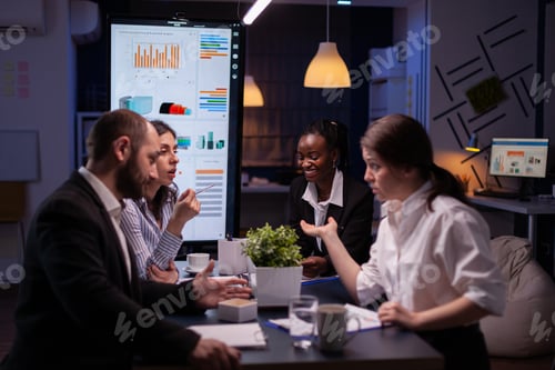 Preview: Diverse multi-ethnic businesspeople analyzing management strategy working overtime