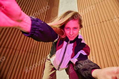 Preview: Portrait of Young Woman Taking Selfie Energetically