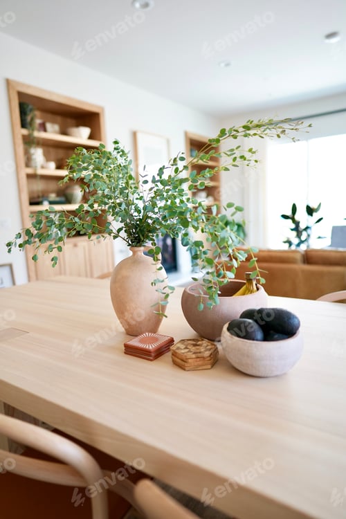 Preview: Home decor styling with green plants and vases on dining table