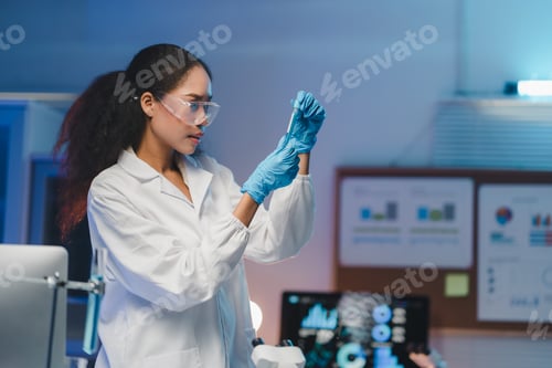 Preview: Scientist analyzing liquid in test tube in modern laboratory