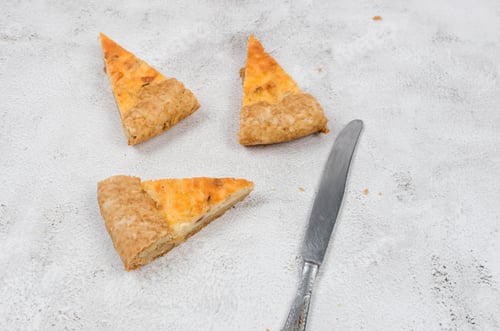 Preview: Delicious Quiche Slices with Knife on Table