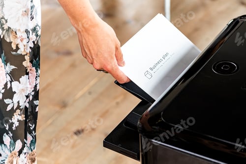Preview: Taking a business plan paper from printer