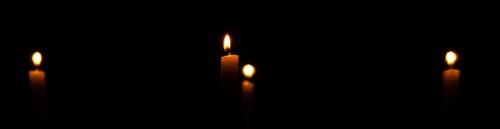 Preview: Panoramic shot of candles in the dark