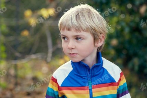 Preview: Young boy lost in thought outdoors