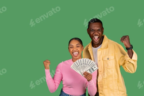 Preview: Emotional young african american couple with money cash clenching fists