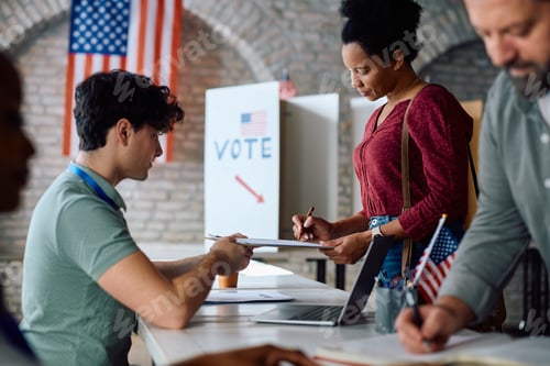 Preview: Black woman signing up to vote at polling place during US elections.