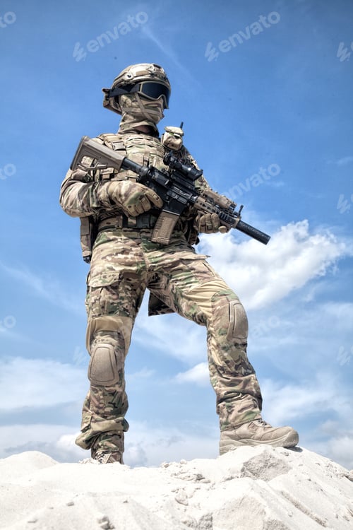 Preview: Airsoft player witt gun taking part in war games