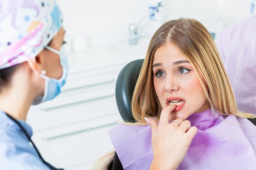 Preview: Worried patient touching teeth at the dental clinic