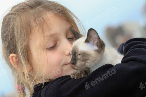 Preview: Young Girl Holding Kitten Outdoors