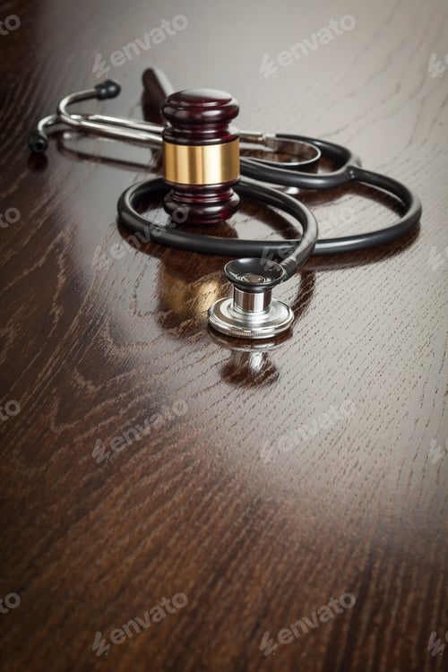 Preview: Gavel and Stethoscope on Reflective Table