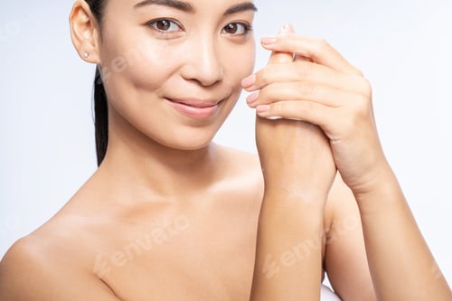 Preview: Beautiful young woman takes care of her hands in studio