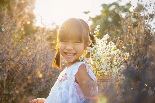 Preview: Portrait fun happy little cute asian girl playing in meadow flower field in spring or summer