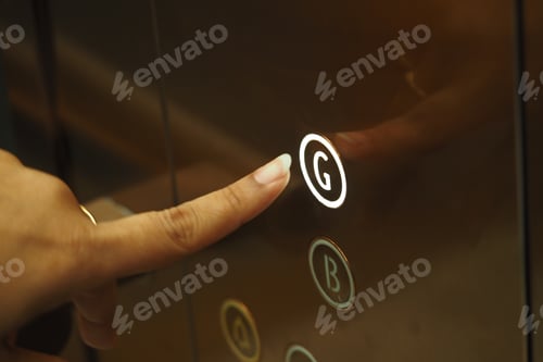Preview: Finger pressing the elevator button for ground floor access