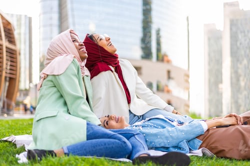Preview: Beautiful muslim girl wearing hijab bonding outdoors