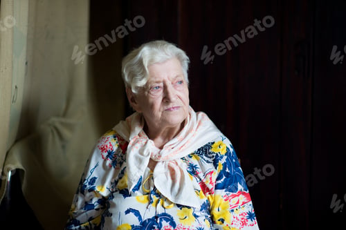 Preview: Portrait of old woman looking through the window