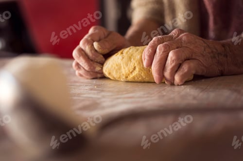 Preview: Elderly woman kneading dough