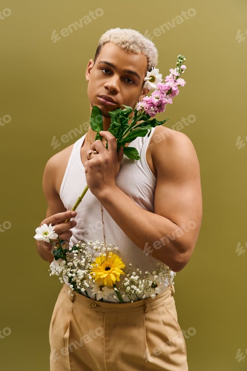 Preview: Captivating young man showcasing floral elegance in a trendy studio setting