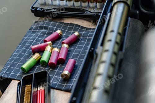 Preview: Shotgun rifle with cartridges on table in a weapon workshop