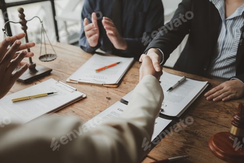 Preview: Business people negotiating a contract, discussing contract while working together in sunny modern o