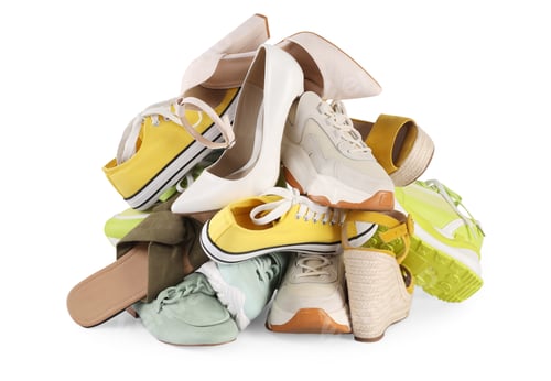 Preview: Pile of different female shoes isolated on white