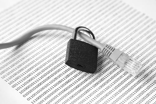 Preview: Grey cable and a black lock on a piece of paper with some codes on it