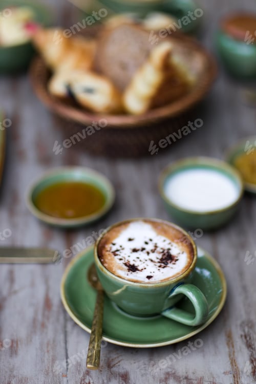 Preview: Cup of aroma cappuccino at breakfast with croissants